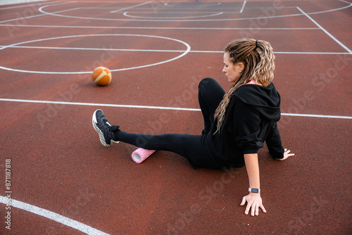 A woman does an exercise on a roller photo