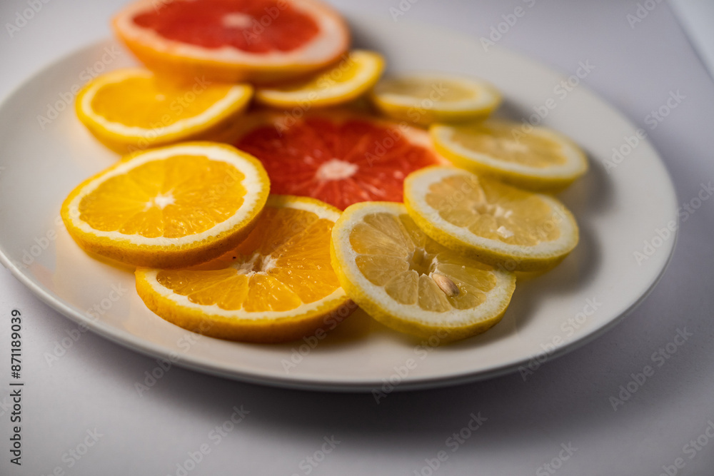 grapefruit and lemon slices on white plate grapefruit and lemon slices on white plate