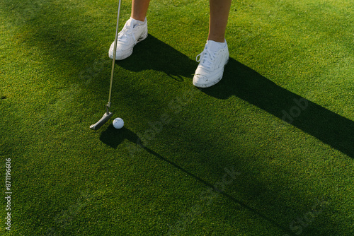 Close up of legs of young woman playing golf 