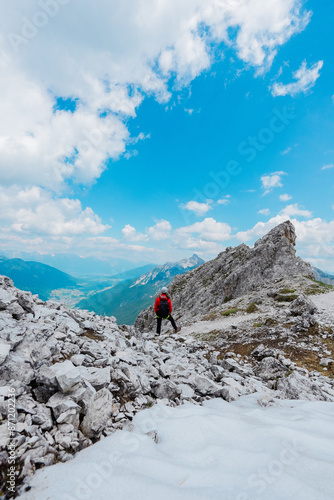 Climber on the Snowy Summit of the Mountain Looking into the Landscape