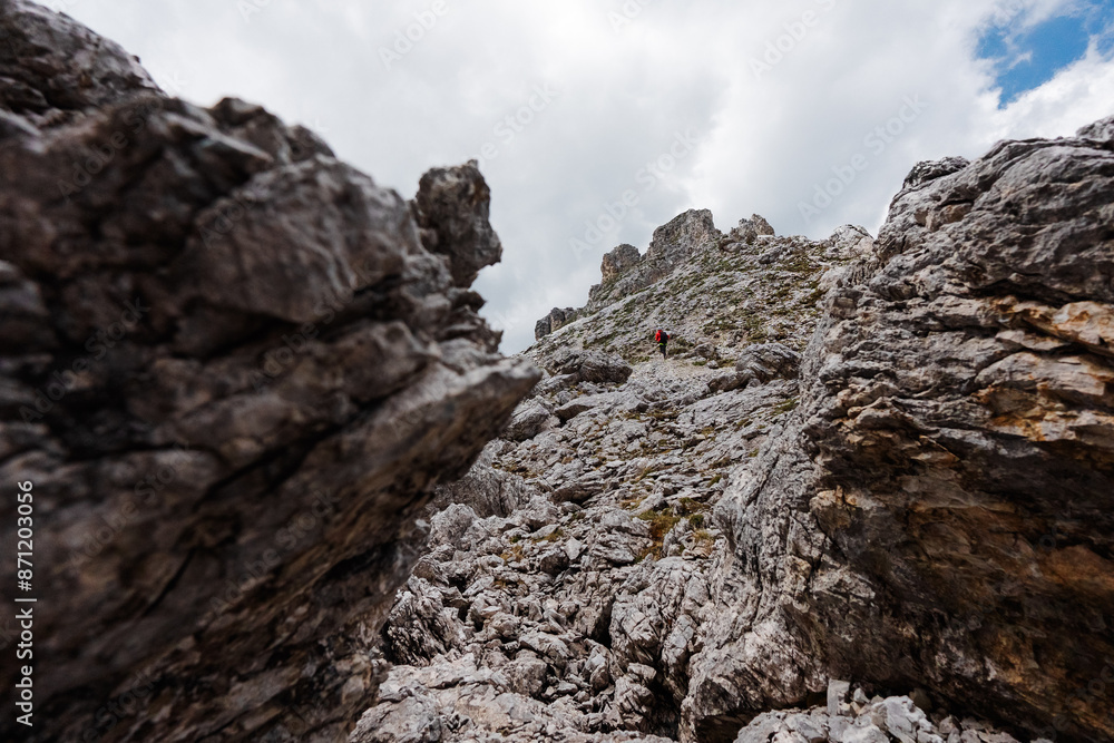Hiker Hiking Up the Rocky Stone Path Up to the Peak of the Mountain Hiker Hiking Up the Rocky Stone Path Up to the Peak of the Mountain