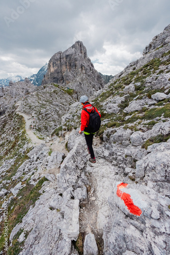 Hiker Walking on a Mountain Ridge in an Alpine Landscape photo