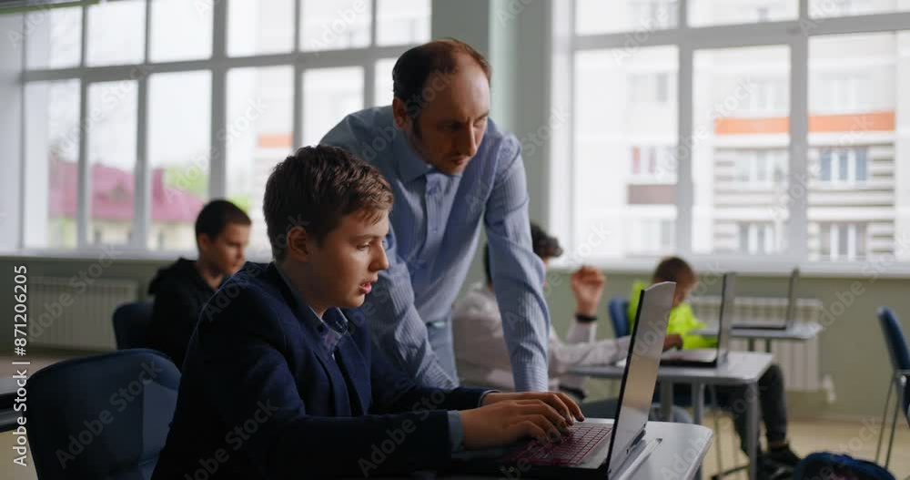 Teen Boy Consulting With Teacher In Classroom, Future Programmer Studying In School Teen Boy Consulting With Teacher In Classroom, Future Programmer Studying In School