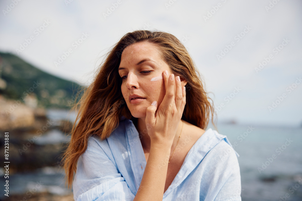 Beautiful woman applies face cream Beautiful woman applies face cream