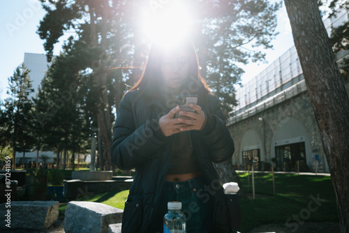 Person Using Smartphone Outdoors photo