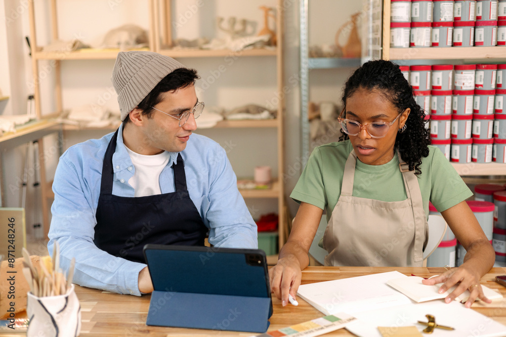 © Artem Podrez/Stocksy - Two small business partners Working in Creative Studio