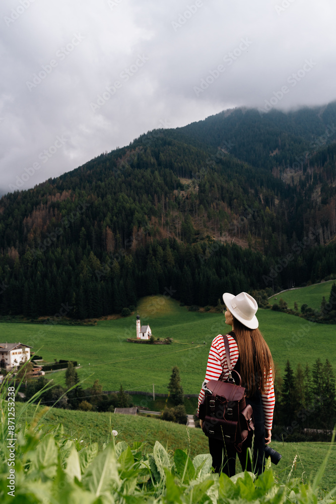 Woman exploring old church in Dolomite Alps Woman exploring old church in Dolomite Alps