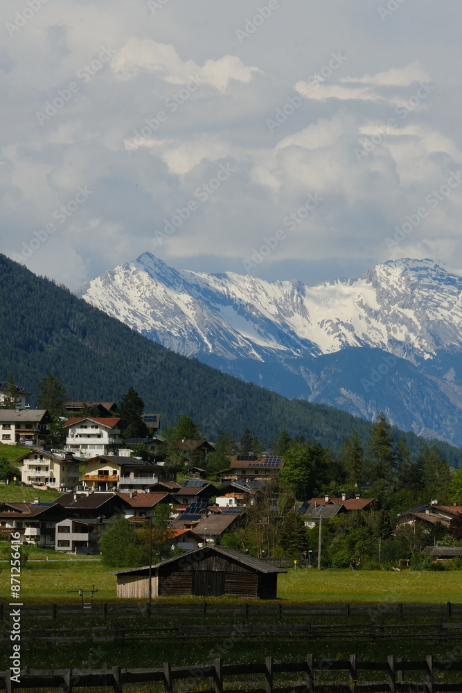 Austrian village with snowy mountains on background. Austrian village with snowy mountains on background.