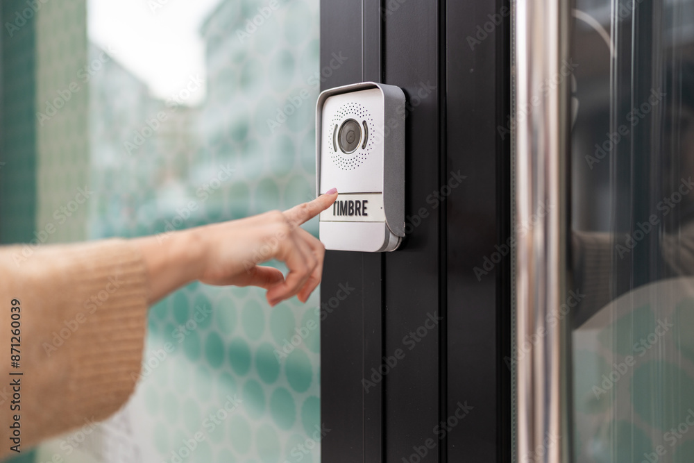 Person ringing the front doorbell. Person ringing the front doorbell.