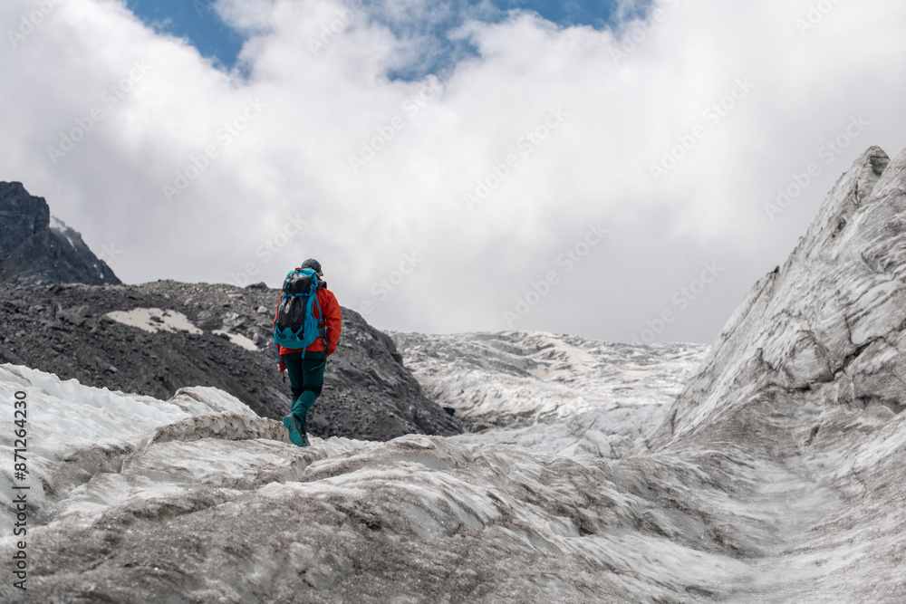 Alpinist walking up a glacier Alpinist walking up a glacier