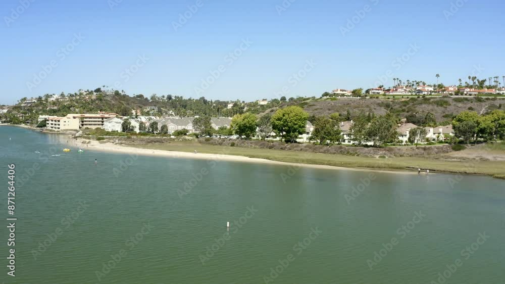 Aerial View of kayakers in Carlsbad Lagoon on a sunny day in San Diego California with blue sky and views of the city and shorelines Aerial View of kayakers in Carlsbad Lagoon on a sunny day in San Diego California with blue sky and views of the city and shorelines