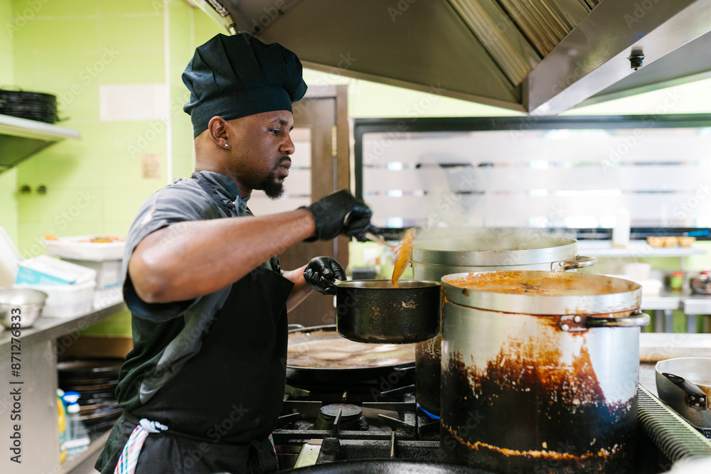 Chef Cooking Sauce in Busy Kitchen Chef Cooking Sauce in Busy Kitchen