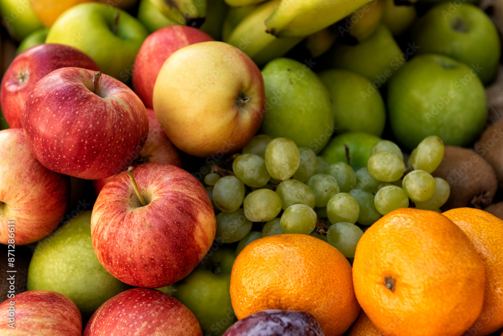 Selection of fruits: apples, bananas, grapes, oranges, kiwis and plums Selection of fruits: apples, bananas, grapes, oranges, kiwis and plums