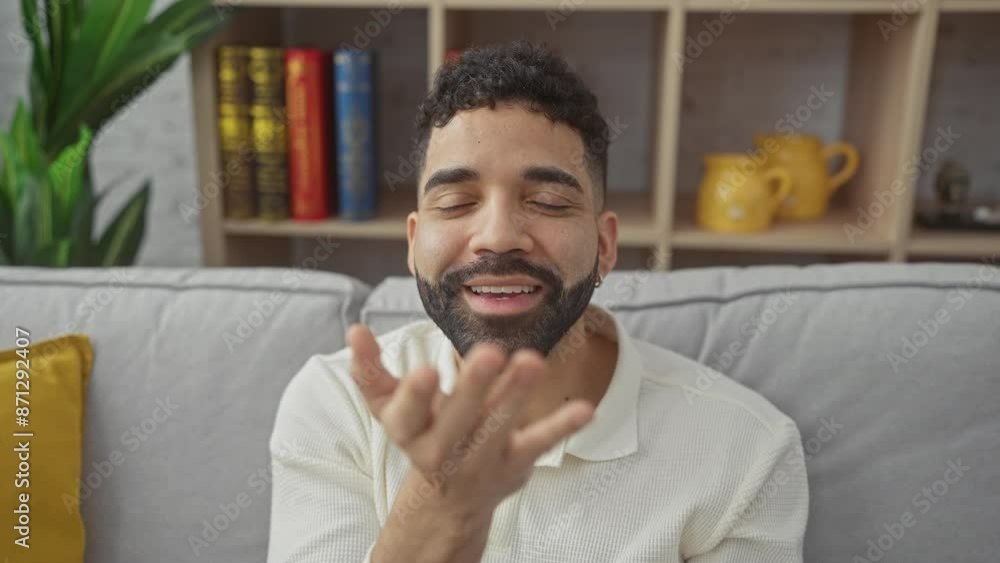 Young hispanic man at home, blowing a loving kiss to the camera with a sexy look and lovely expression Young hispanic man at home, blowing a loving kiss to the camera with a sexy look and lovely expression
