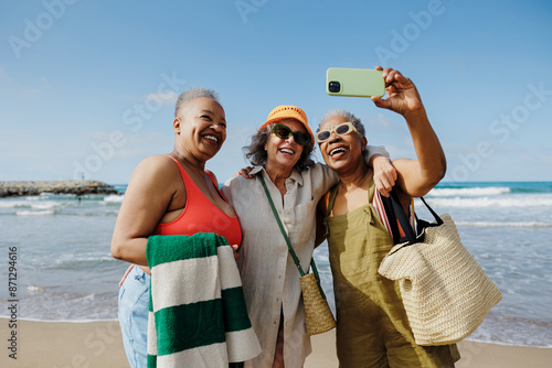 Senior women taking a selfie on a sunny beach day