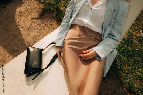 Midsection of a woman in stone deckchair