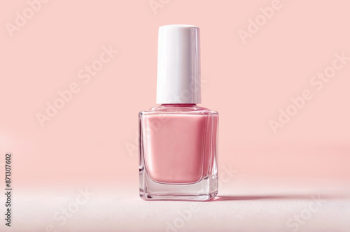 The bottle of nail polish are displayed on a beige pastel background, Copy space photo