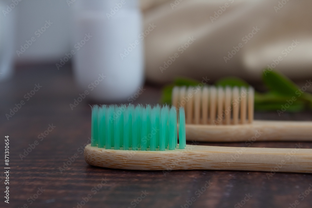 Pair of bamboo brushes on wooden table. Sustainable dental hygiene Pair of bamboo brushes on wooden table. Sustainable dental hygiene