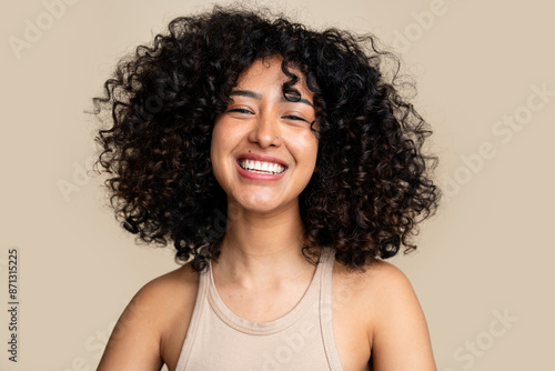 woman with curly hair laughing joyously