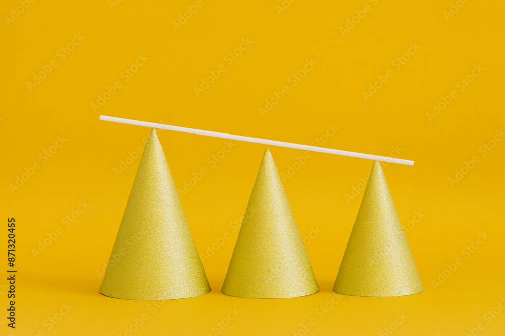 Shiny golden pyramid cones aligned according to height Shiny golden pyramid cones aligned according to height