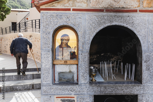 Votive candles near an icon of the Virgin Mary