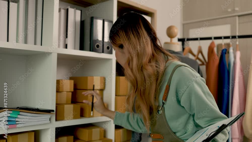 an entrepreneur works in her clothes shop and is organizing so many thing in order, clothing store business owner is taking time to check her product even it's to late because she loves her business an entrepreneur works in her clothes shop and is organizing so many thing in order, clothing store business owner is taking time to check her product even it's to late because she loves her business