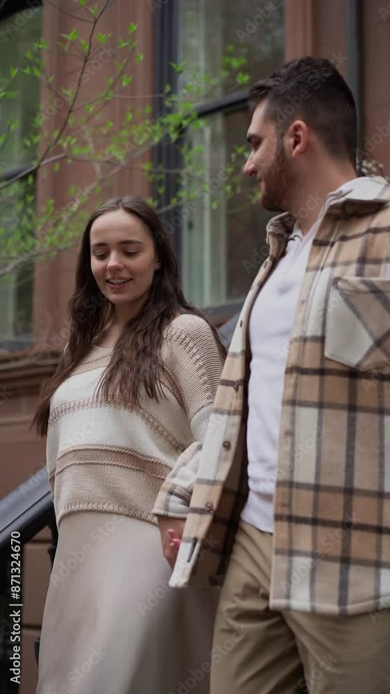 Couple sitting on steps of brownstone building, enjoying each others company Couple sitting on steps of brownstone building, enjoying each others company