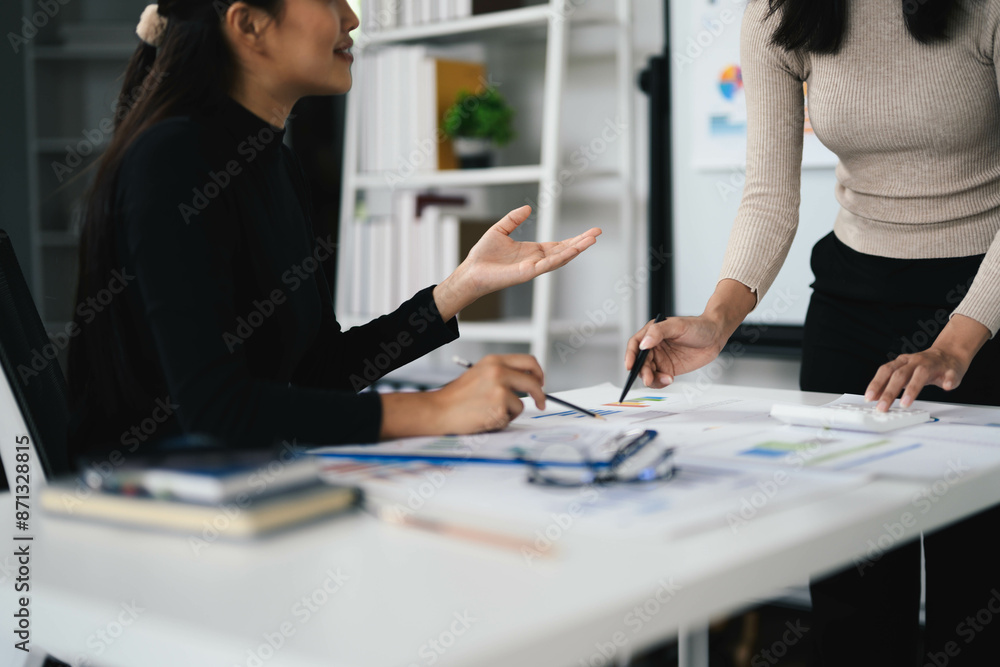 Collaborative Team Meeting in Modern Office with Two Women Discussing Business Plans and Documents Collaborative Team Meeting in Modern Office with Two Women Discussing Business Plans and Documents