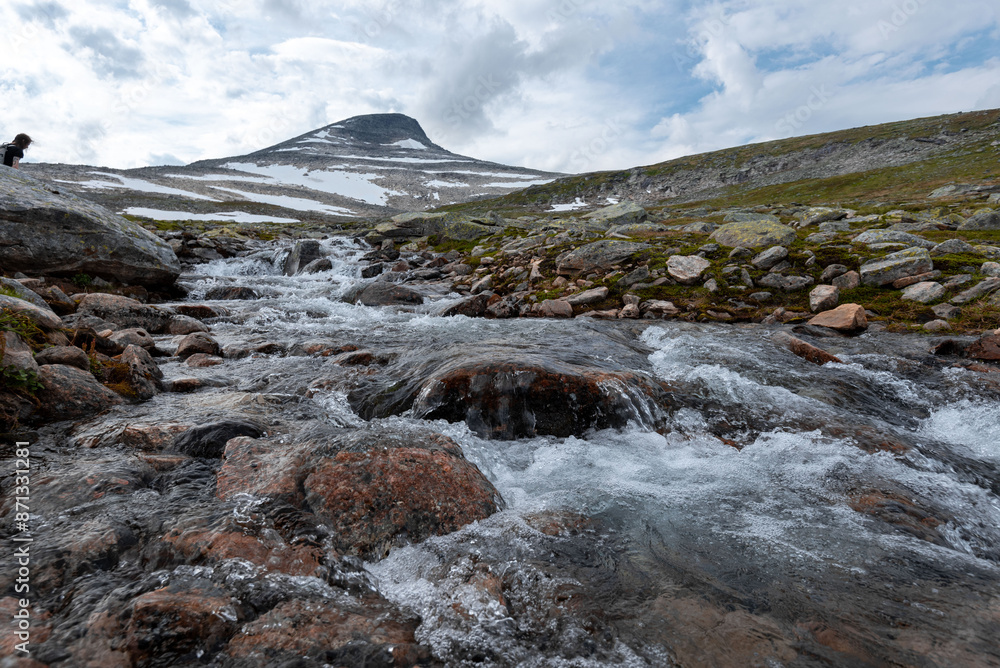 Flowing water down a mountain stream at the arctic circle on Bolnatind, Helgeland, Norway. Wild polar falls in northern scandinavia. Fjelltur in norwegian wetlands and mountains. High resolution Flowing water down a mountain stream at the arctic circle on Bolnatind, Helgeland, Norway. Wild polar falls in northern scandinavia. Fjelltur in norwegian wetlands and mountains. High resolution