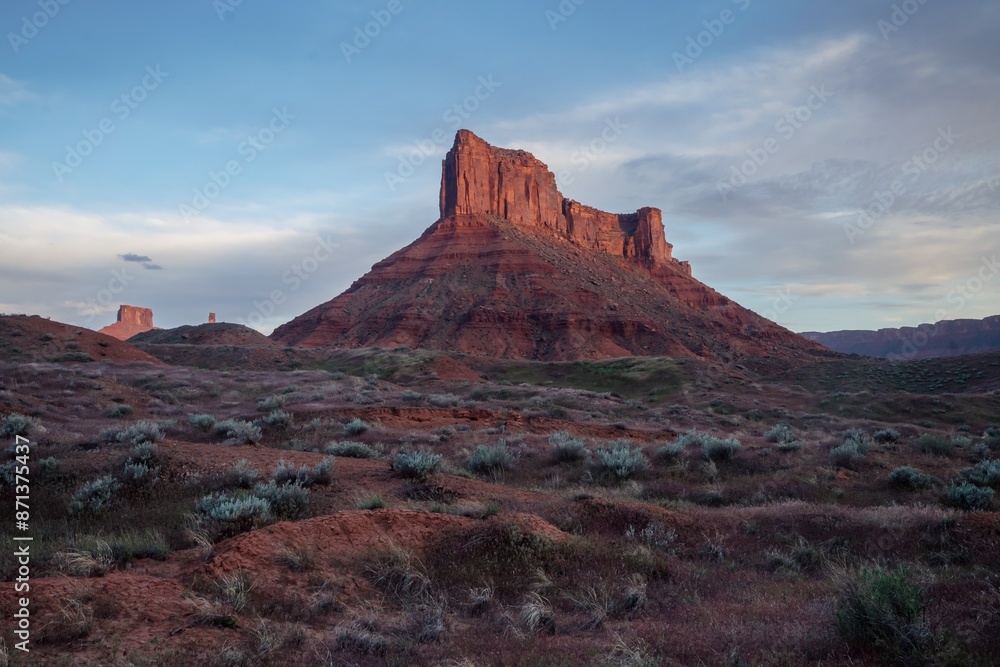 Canyon, green trees and buttes at sunrise in Moab, Utah, United States of America. Canyon, green trees and buttes at sunrise in Moab, Utah, United States of America.