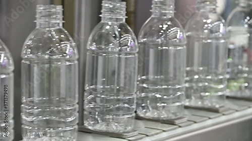 The  empty drinking water bottles  on the conveyor belt for filling process.