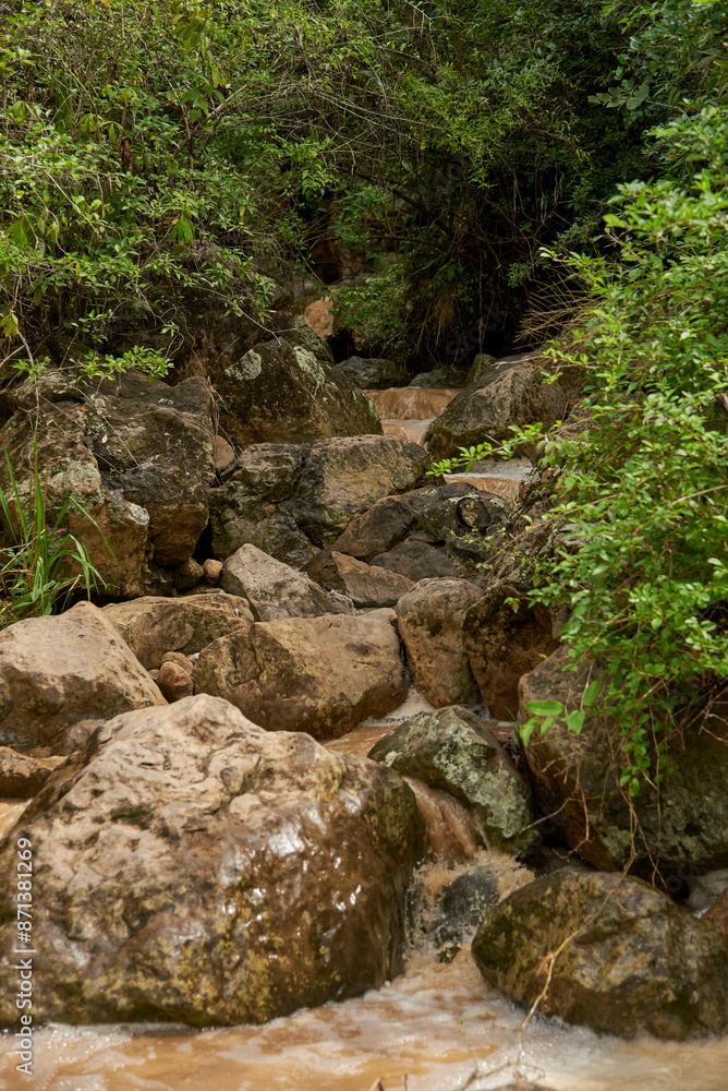 Mountain stream, water flowing between the rocks of a small creek in the area of Barichara, Santander, Colombia. Mountain stream, water flowing between the rocks of a small creek in the area of Barichara, Santander, Colombia.