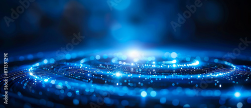 Abstract image of luminous particles in a circular pattern on a dark background, depicting a futuristic and cosmic theme with blue light.
