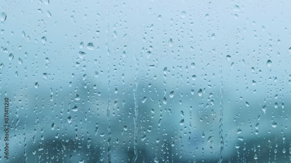 Close-up of rain droplets falling on window. Rainy day. Close-up of rain droplets falling on window. Rainy day.