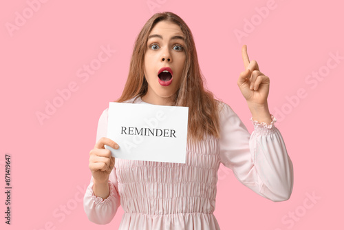 Excited young woman holding...