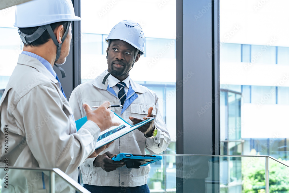 Group of multinational engineers having a conversation in a facility Group of multinational engineers having a conversation in a facility