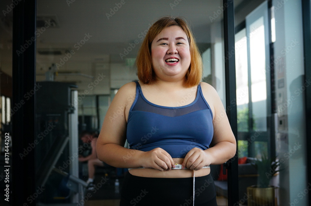 Obese woman with fat belly in dieting concept. Overweight woman touching his fat belly and want to lose weight. Fat woman her waist with a centimeter. Shape up healthy stomach muscle and diet Obese woman with fat belly in dieting concept. Overweight woman touching his fat belly and want to lose weight. Fat woman her waist with a centimeter. Shape up healthy stomach muscle and diet