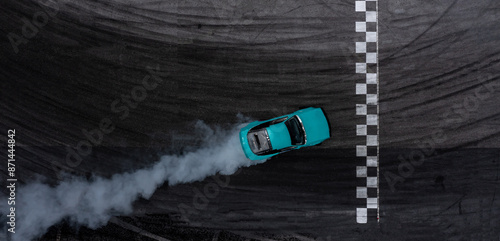 Obraz na płótnie Aerial top view car drifting diffusion race drift car with lots of smoke from burning tires on speed track, Professional driver drifting car with lots of white smoke . w salonie