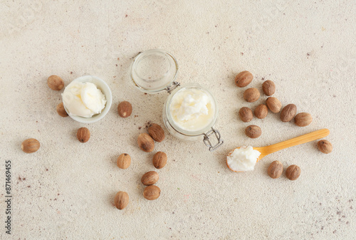 Composition with shea butter and nuts on light background