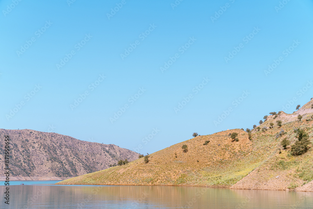 A mountain range with a lake in the foreground A mountain range with a lake in the foreground