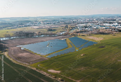 Solar photovoltaic power plant in a field at sunset