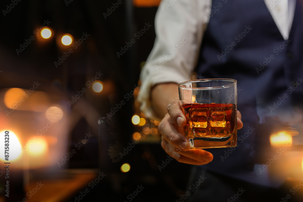 Bartender pouring Whiskey, on bar Bartender pouring Whiskey, on bar