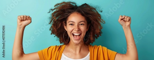 A full-body shot of a woman feeling exhilaration with a turquoise background, ample copy space