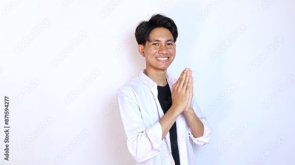 Young smiling Asian man gesturing welcome Young smiling Asian man gesturing welcome