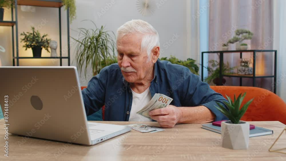 Rich happy senior old man counting money cash use laptop computer calculate domestic bills at home indoors. Elderly grandfather pensioner satisfied of income earnings, saves money for vacation gifts Rich happy senior old man counting money cash use laptop computer calculate domestic bills at home indoors. Elderly grandfather pensioner satisfied of income earnings, saves money for vacation gifts