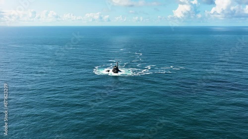 A lighthouse rising out of the ocean. Fastnet lighthouse photo