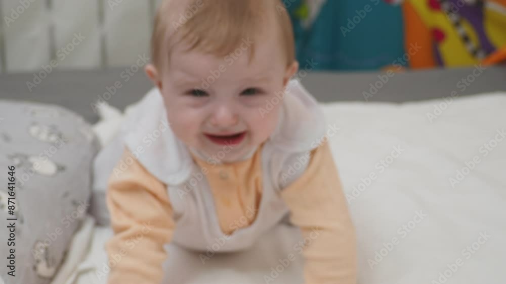 Adorable happy blonde infant baby playing with kids toys at home while sitting on carpet floor in living room. Portrait of smiling cute child toddler using colorful toys, copy space Adorable happy blonde infant baby playing with kids toys at home while sitting on carpet floor in living room. Portrait of smiling cute child toddler using colorful toys, copy space