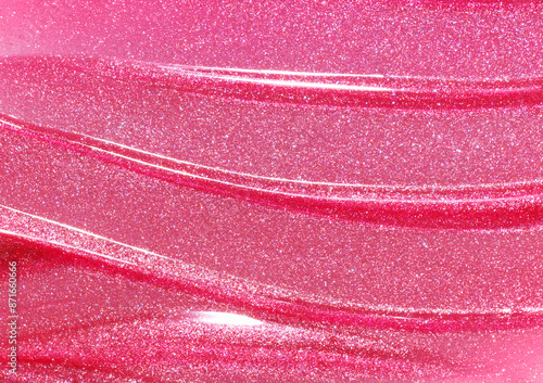 Pink shimmering lip gloss texture background. Smudged cosmetic product smear. Makup swatch product sample