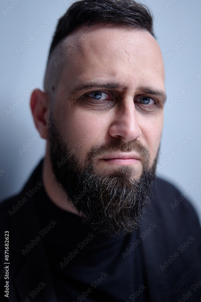 Studio portrait of young sceptical handsome man with beard. Studio portrait of young sceptical handsome man with beard.