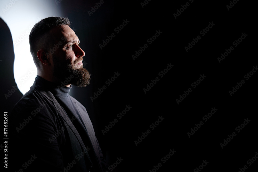 Studio portrait of young handsome man with beard. Studio portrait of young handsome man with beard.